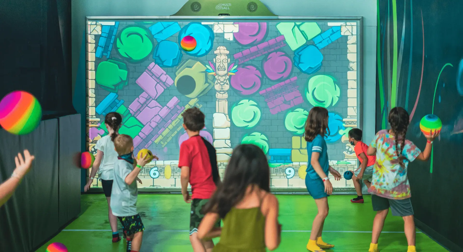 Players enjoying games on a MultiBall interactive sports wall