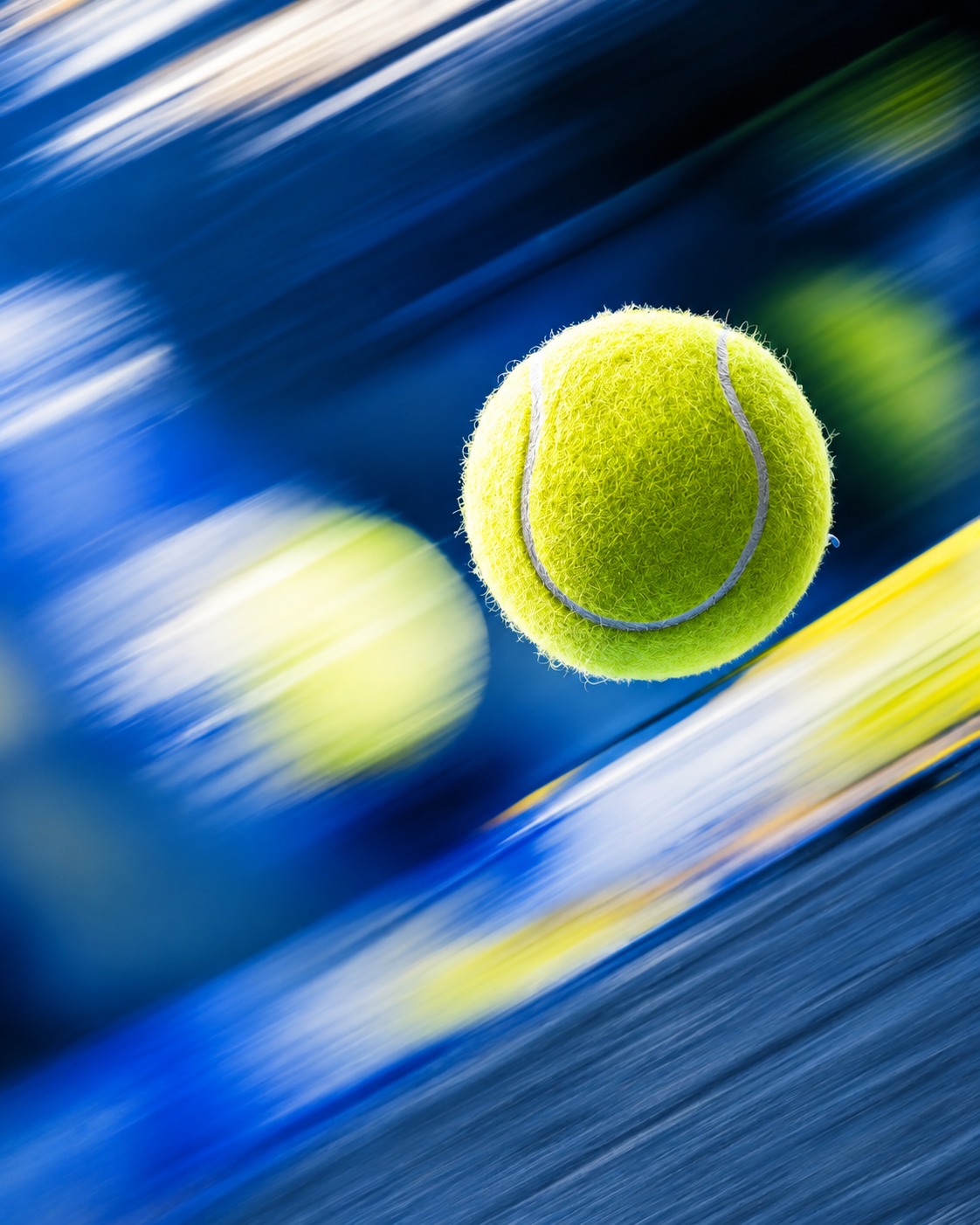Tennis ball moving quickly across a blue court