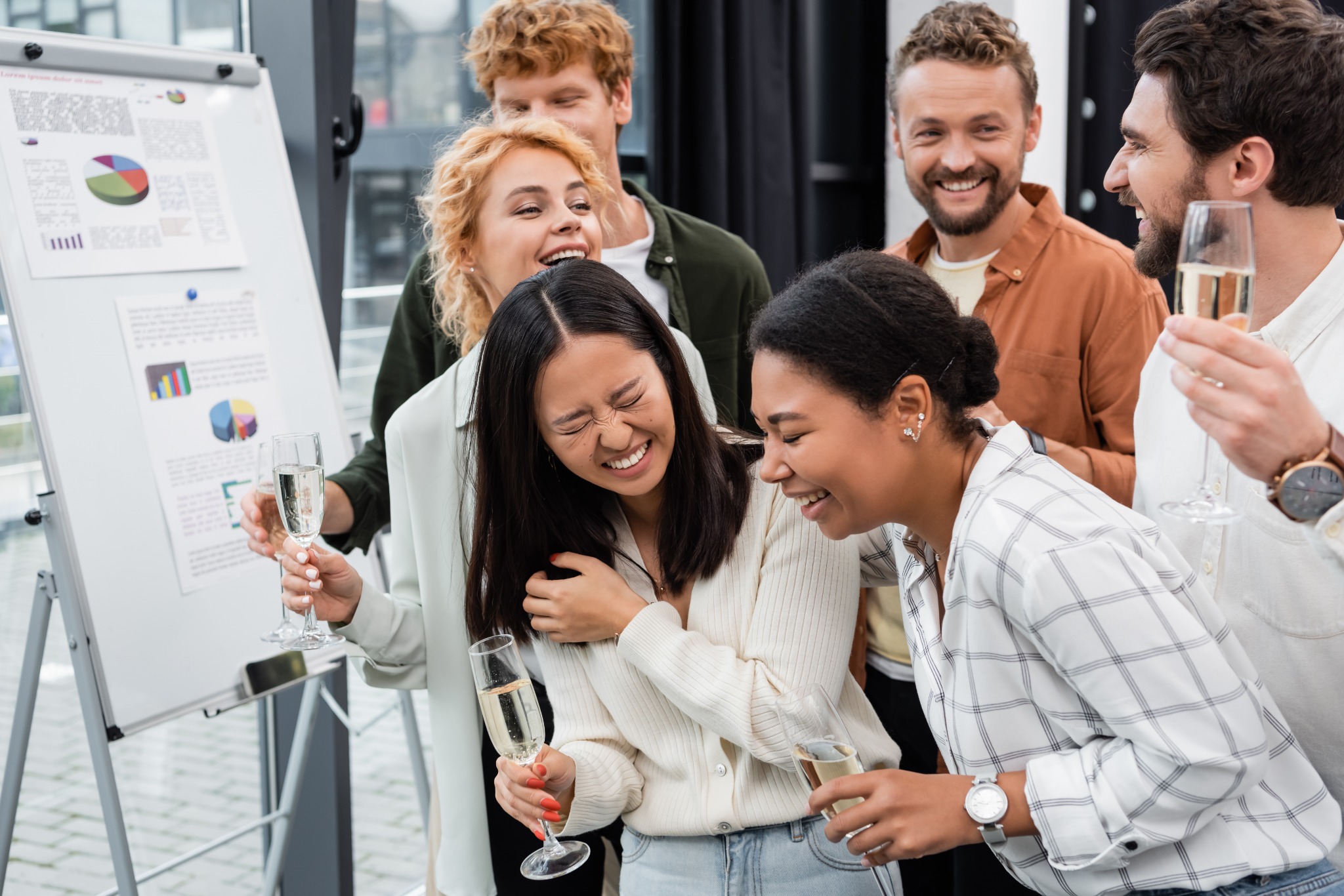 Colleagues laughing and celebrating a company success together